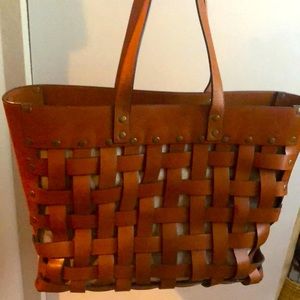 Leather bag with khaki lining. 14” H; 18” W; 6.5”D